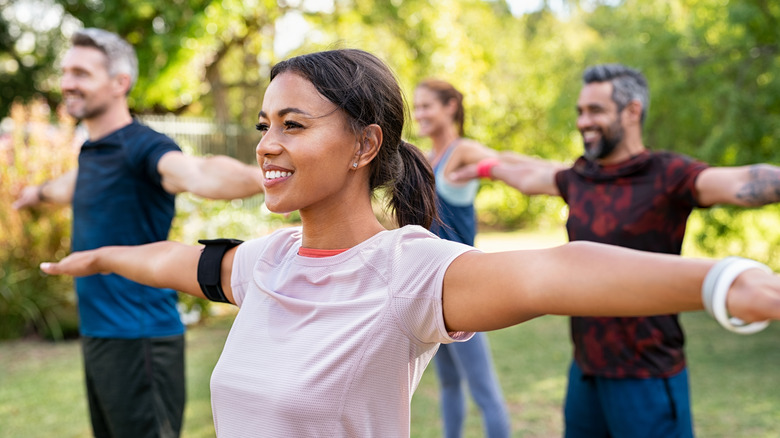 men and women in outdoor workout class