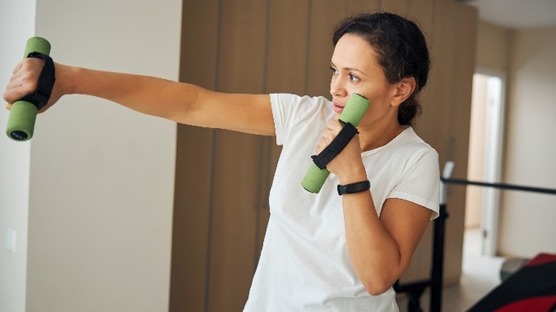 Woman shadowboxing with weights