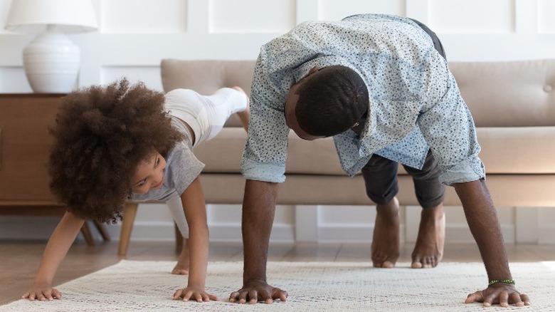 Father and daughter doing pushups