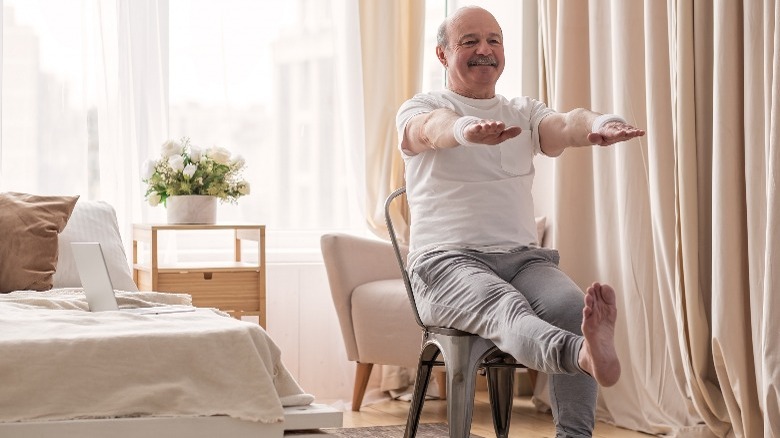 Older man exercising in chair