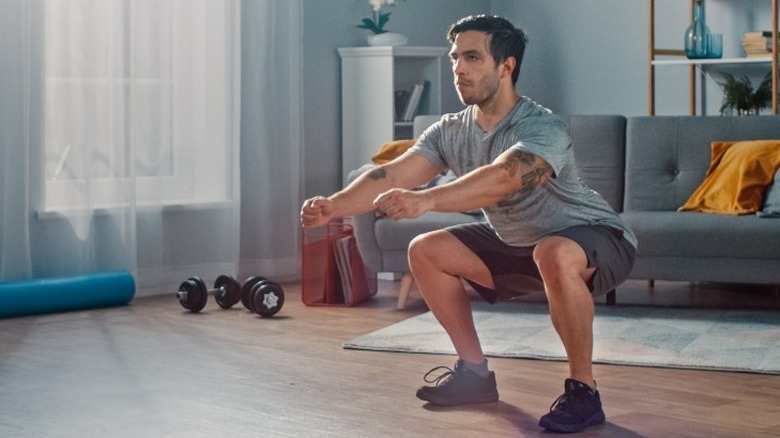 Young man doing squats