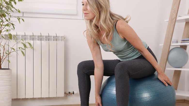 Woman sitting on stability ball