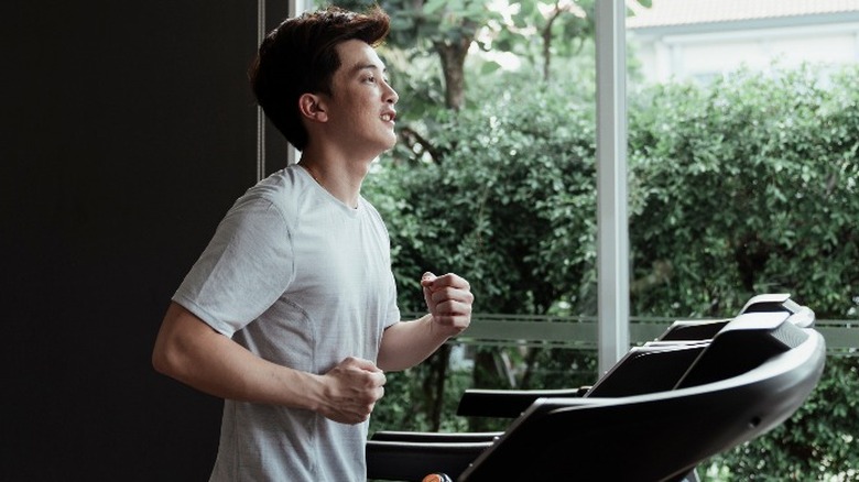 Young man on treadmill at home