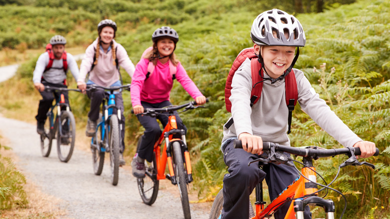 family enjoying an outdoors bike ride