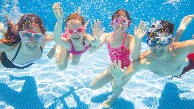 family enjoying swimming in pool