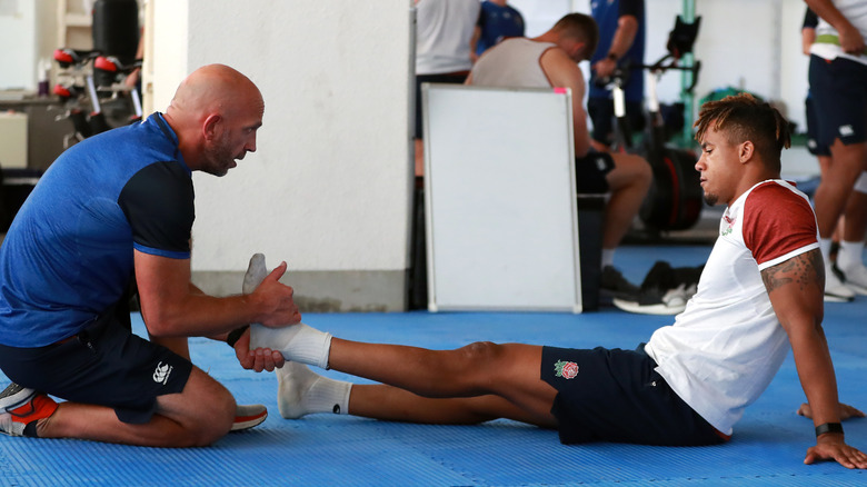 physical therapist exercising foot