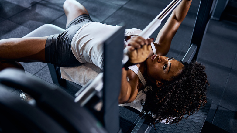 woman using gym bench press