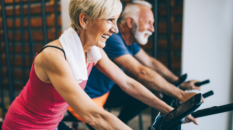 older couple cycling indoors