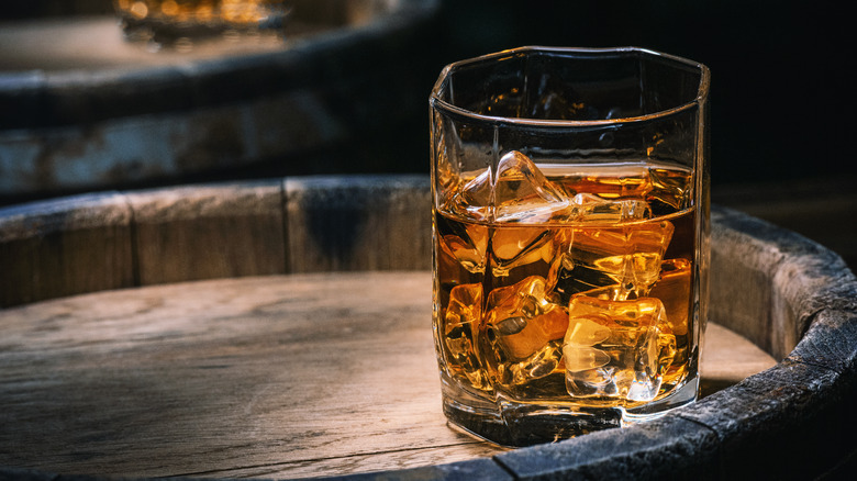 A glass of whisky on a barrel