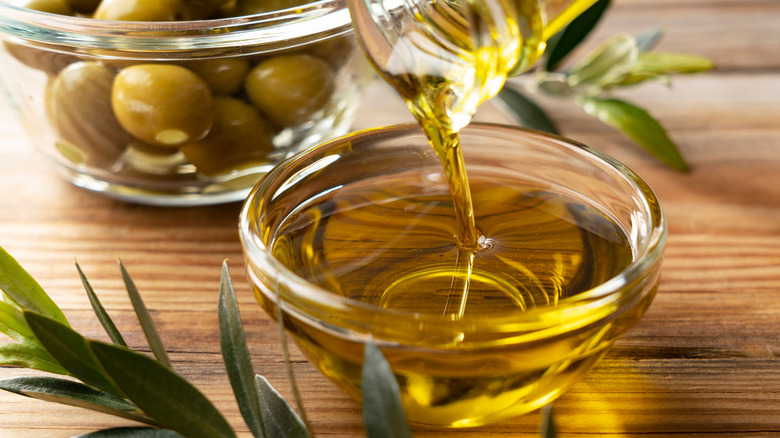 Olive oil poured into glass bowl