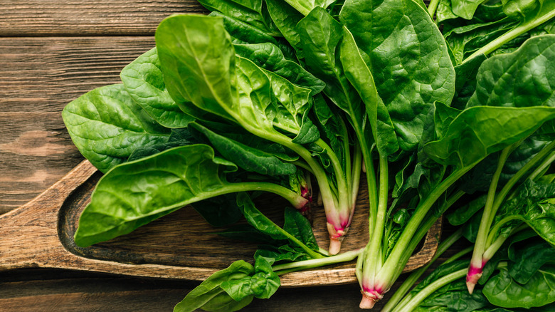 Fresh spinach on a wooden background