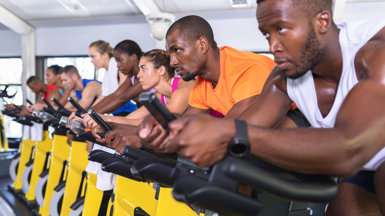 men and women at spin class