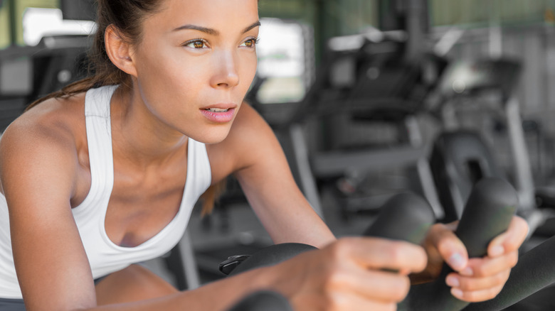 woman holding tightly to handlebars