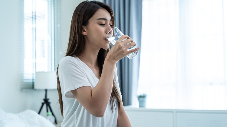 woman drinks a glass of water