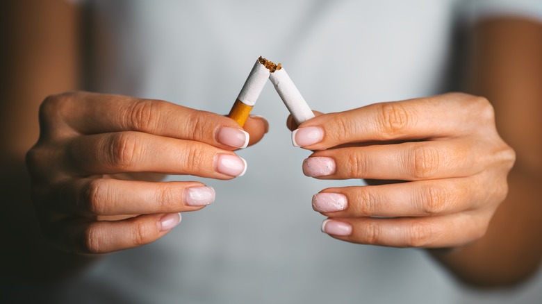 hands breaking cigarette symbolizing quitting smoking