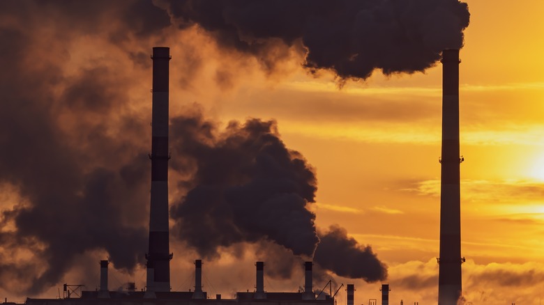 factory smoke stack with sunset background