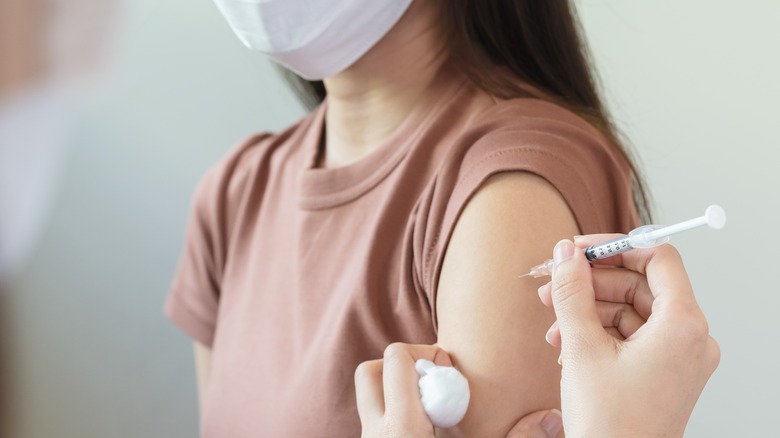 woman getting a vaccine injection in her arm