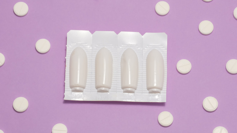 vaginal suppositories on purple background