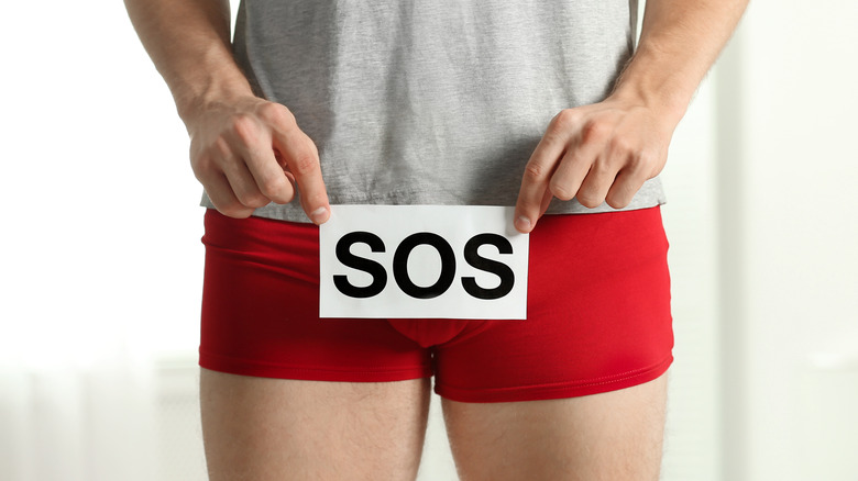 Man holding sos sign