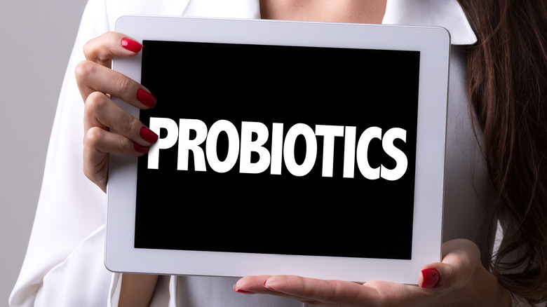 doctor holding tablet with text probiotics