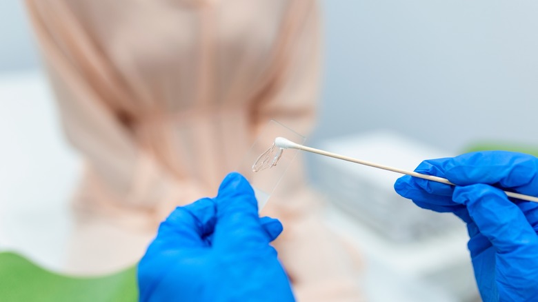 Doctor's hand holding swab sample