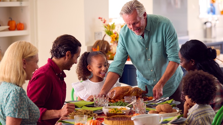 Smiling family eating holiday dinner