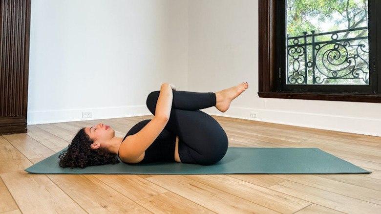 woman doing apanasana