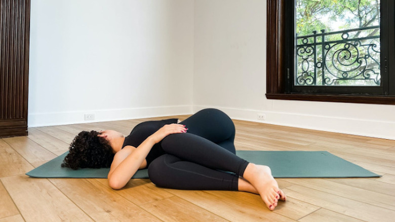 woman doing yoga twist 
