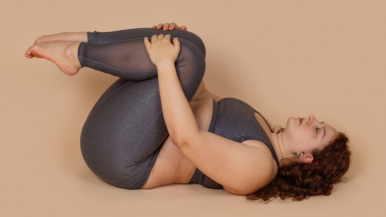 Woman in knees-to-chest pose
