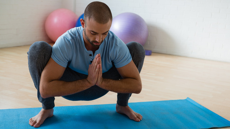 man in garland pose