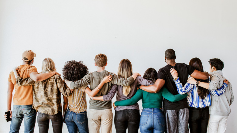 Group with arms around each other