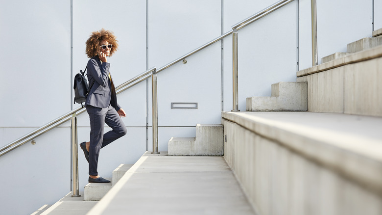 Woman on the phone walking up stairs