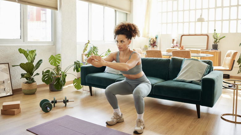 Woman doing squats at home