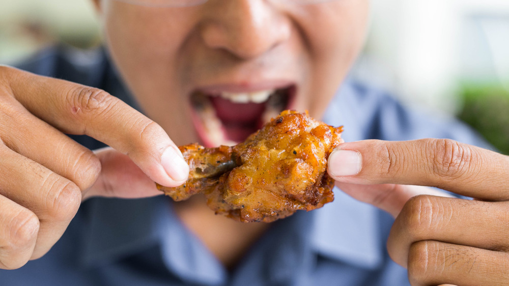 Man eating chicken wings