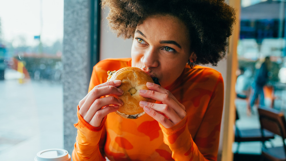 Woman eating a bagel