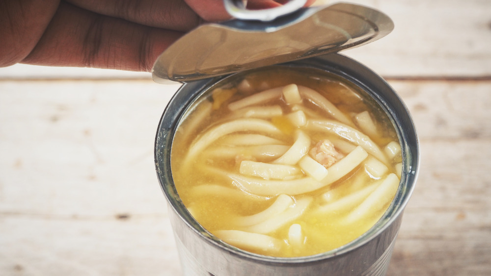 Opening can of chicken noodle soup