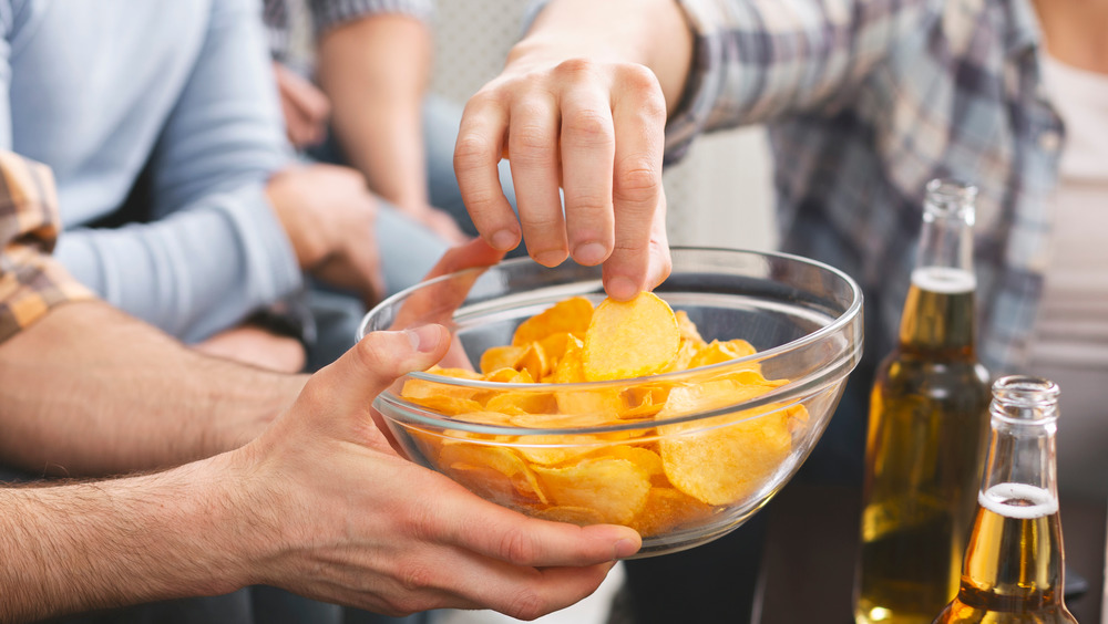 People eating potato chips