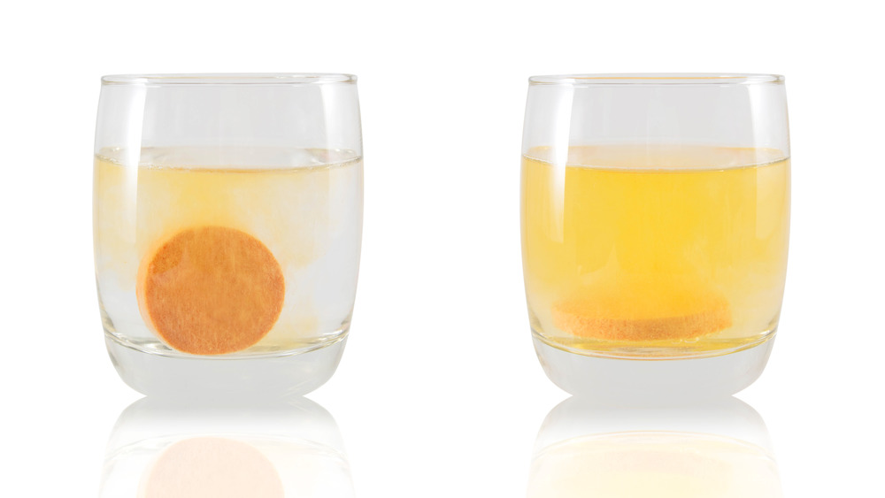 Effervescent Vitamin C tablet dissolving in two glasses of water