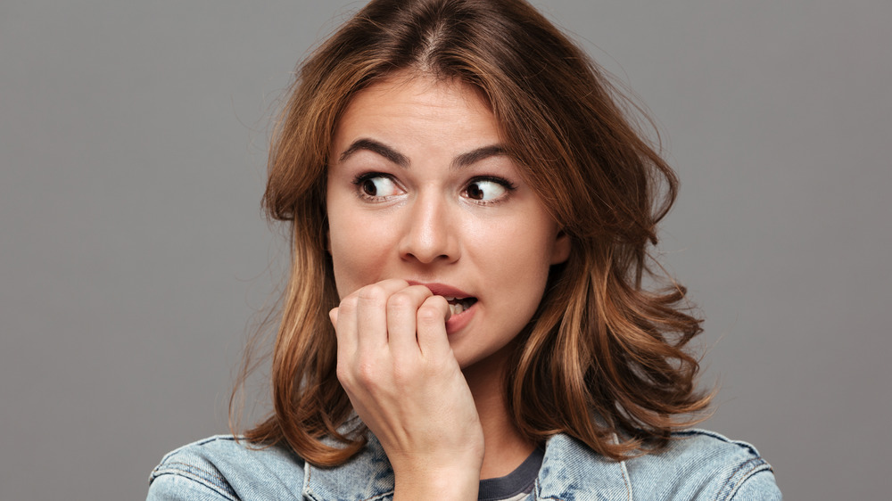 woman biting nails