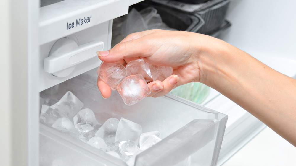 taking ice cubes from freezer