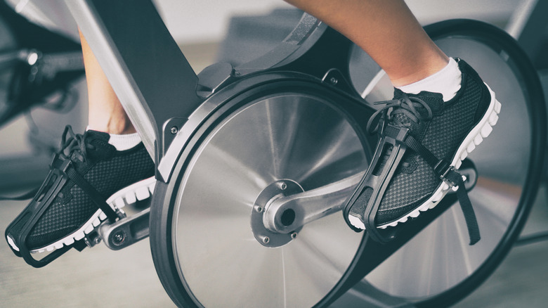 close up of a mans shoes on a spinning bike 