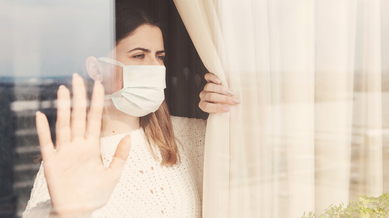 woman looking out her window