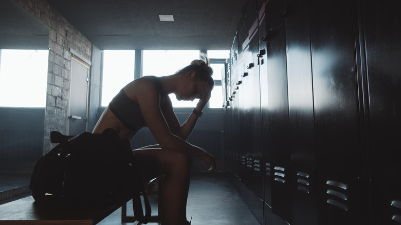 tired woman in locker room