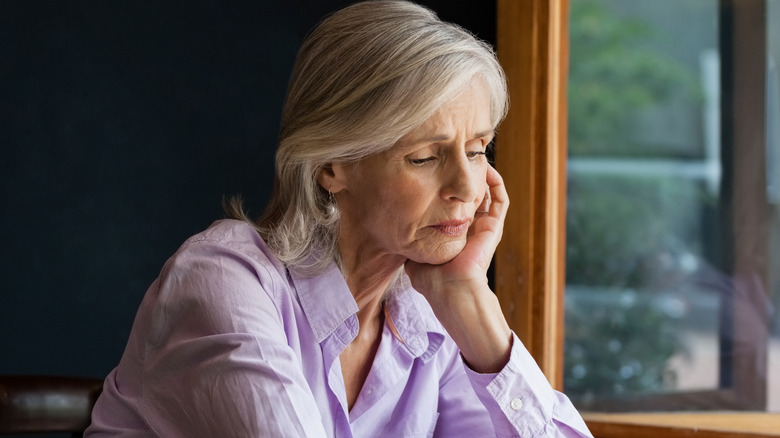 woman in cafe spacing out