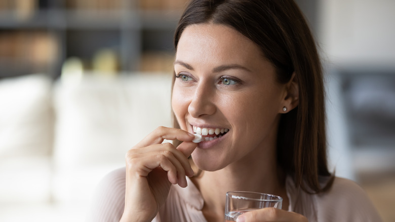 Woman taking a multivitamin