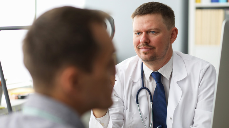 doctor looking at patient in disbelief