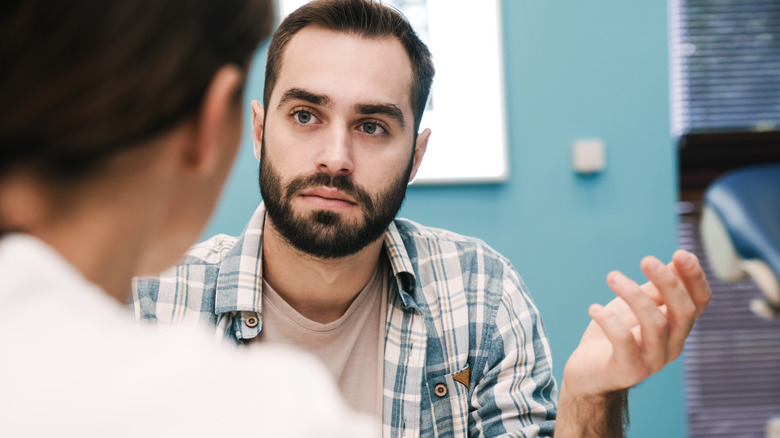 man speaking to doctor