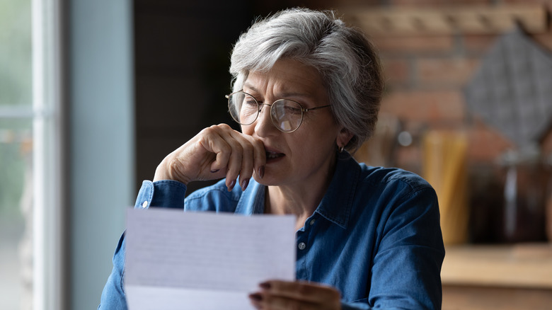 woman looking at paper