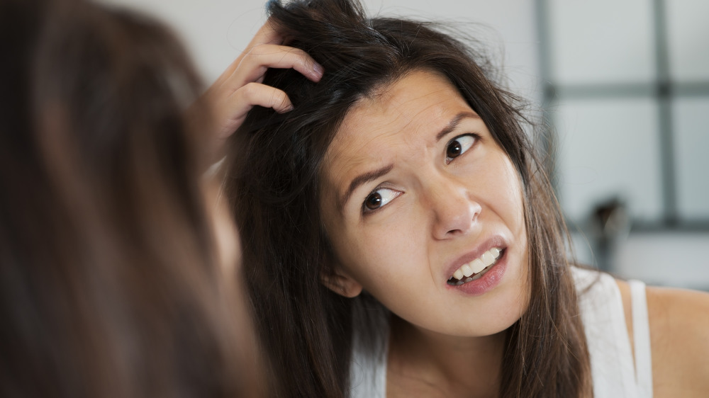 woman scratching head/hair