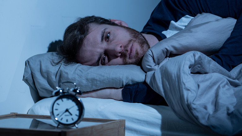 A man with insomnia can't fall asleep